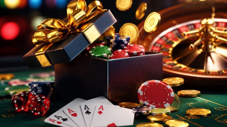 A gift box overflowing with poker chips and playing cards set on a casino table with a roulette wheel in the background.